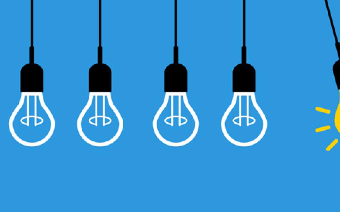 A row of hanging light bulbs, with one glowing yellow bulb standing out among the unlit bulbs against a blue background.